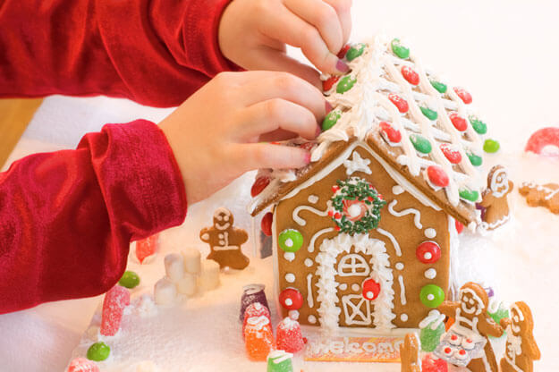 child-decorating-a-gingerbread-house